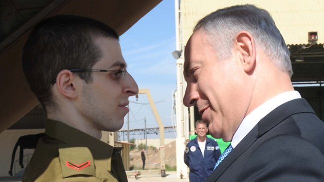 Sgt. Gilad Shalit embraces Israeli PM Benjamin Netanyahu as he arrives back in Israel on Tuesday.  (AP)