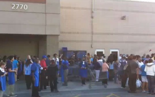 People crowd outside the Walmart where the stabbing took place. (YouTube MassMediaArtistry)