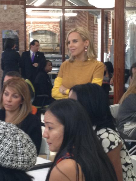 Tory Burch smiles as she listens to other business mentors at Monday's conference. 