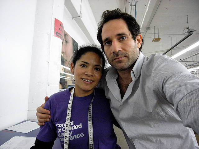 Former CEO and founder Dov Charney poses with an American Apparel factory employee. (Creative Commons)