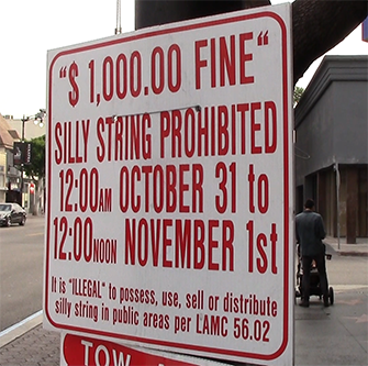Signs advising party-goers of the silly string ban were posted along Hollywood Boulevard the morning of Oct. 28, 2015. (© 2015 Stephanie Haney/Annenberg Media)