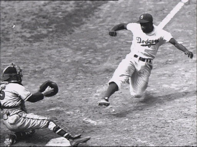 Jackie Robinson stealing home plate (Photo courtesy AP).