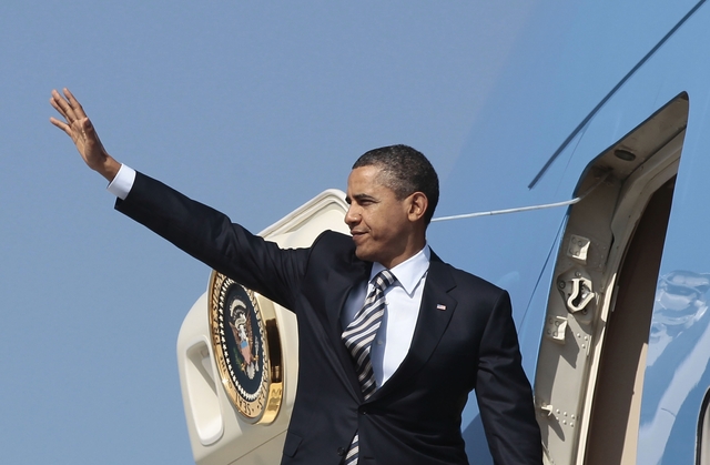 President Obama waves before boarding Air Force One/AP