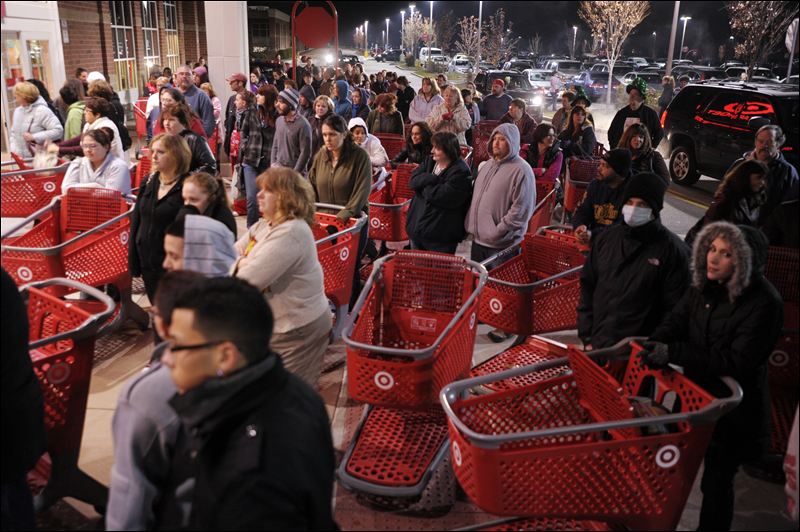 Black Friday shoppers await Target's opening to steal the best deals. (Photo by AP)