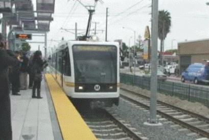 A person boarding a Metro train in Los Angeles.