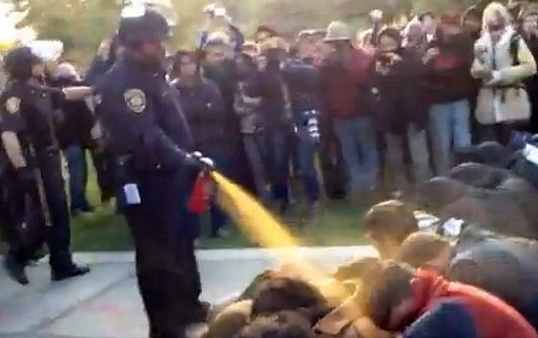 A police officer pepper-sprays unarmed protesters at the Occupy UC Davis protest last November. (Photo courtesy YouTube)