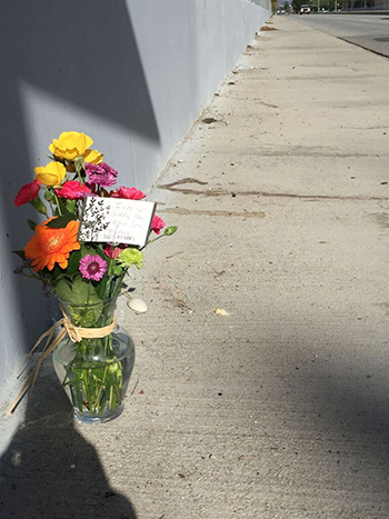 A bouquet of flowers sits behind police tape near the scene of a shooting rampage in San Bernardino. (Whitney Ashton/Annenberg Media)